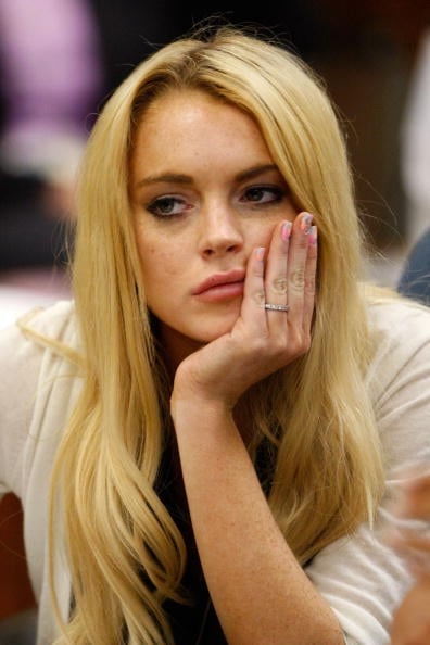 Lindsay is ready for the court cameras, plumped lips, nails, tats and all.