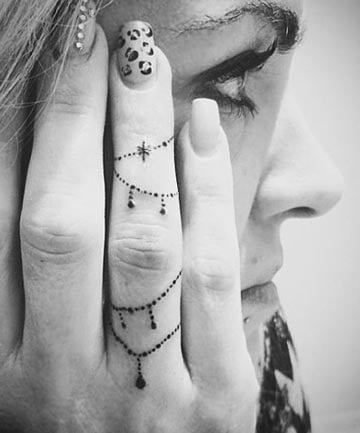 Symbol chain tattoo on the hand.