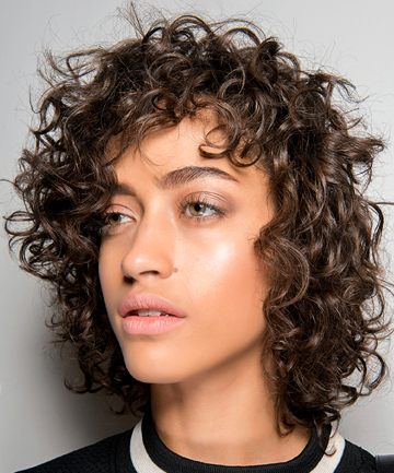 Image of Shaggy curly hair with a side part