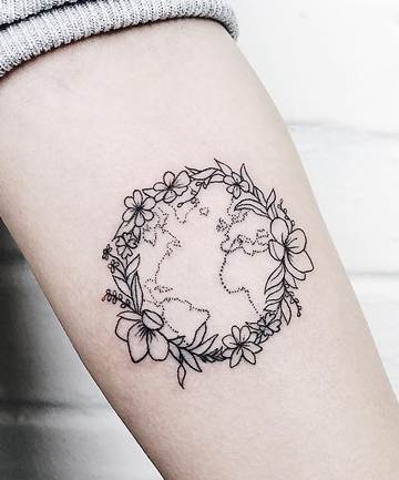 Minimalistic Earth tattoo placed on the wrist.