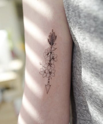 Arrow Tattoo Intertwined With Blossoms