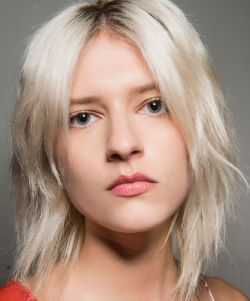 Crop unrecognizable hairdresser using scissors to cut fair hair of client  in beauty salon Stock Photo  Alamy