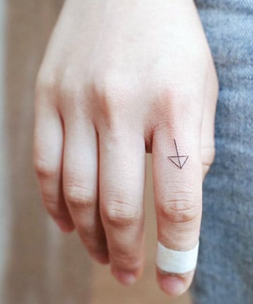 Tiny Arrow Tattoo on Finger